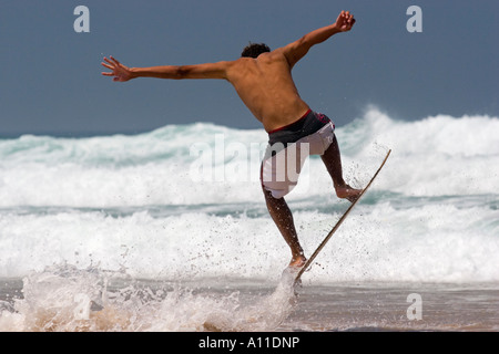 A skimboarder on Cordoama beach, in Algarve (Portugal).  Skimboarder sur la plage de Cordoama, en Algarve (Portugal). Stock Photo