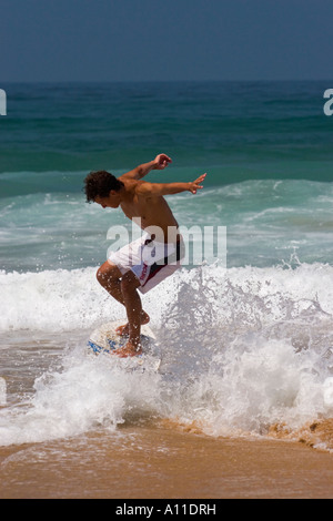 A skimboarder on Cordoama beach, in Algarve (Portugal).  Skimboarder sur la plage de Cordoama, en Algarve (Portugal). Stock Photo