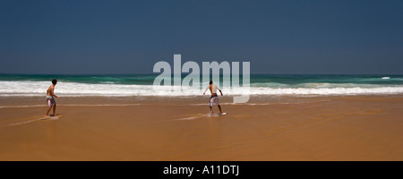 Skimboarders on Cordoama beach, in Algarve (Portugal).  Skimboarder sur la plage de Cordoama, en Algarve (Portugal). Stock Photo