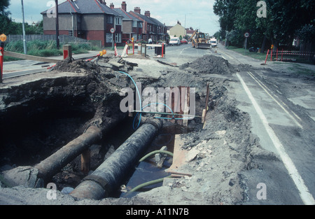 Burst sewer main causes big hole in main road at Caister Stock Photo