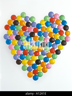 Colourful chocolate smarties shaped in a heart Stock Photo