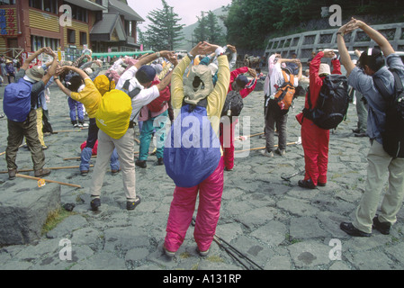 A group of climbers warming up with their guide at The Kawaguchi-ko Fifth Station before climbing Mount Fuji Stock Photo