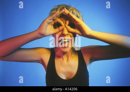 BLONDE HAIR WOMAN MAKING A GRIMACE WITH GLASSES Stock Photo