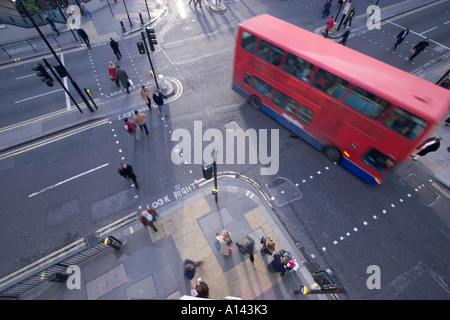 aerial view of Busy traffic intersection crossroads overlooking London street with office workers on lunch break and turning bus Stock Photo