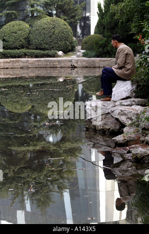 MoCA Shanghai, the Museum of Contemporary Art, reflected in a pond in Renmin (People's) Park, Shanghai, China Stock Photo