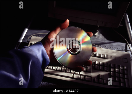 Hand holding CD ROM Stock Photo