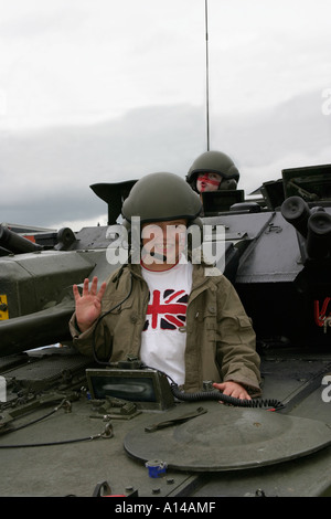 Young boy sitting in army tank at Devon County agricultural show UK Stock Photo