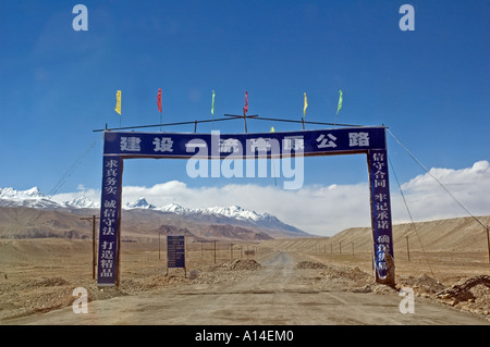 A gate advertising the renovation of the road on the Chinese side of the Khunjerab pass Stock Photo