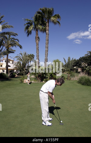 Couple practising golf putting Stock Photo