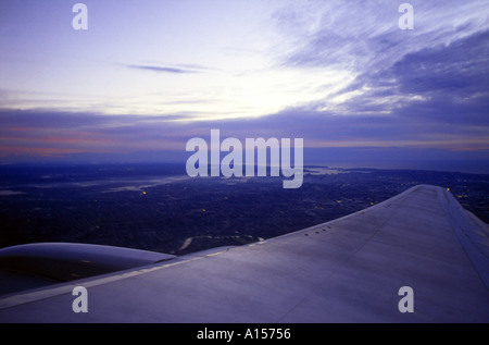 Looking over the the plane wing onto Sydney CBD in early morning Stock Photo