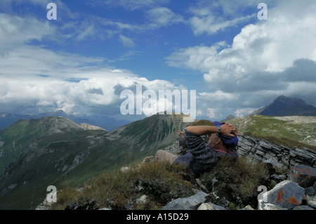Hiker enjoying the view from the top. Stock Photo