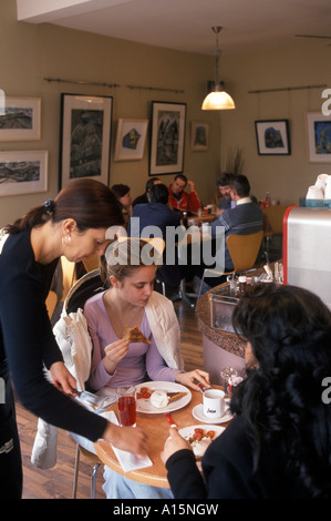 Two customers being served by a waitress in Cafe Brava in the trendy Pontcanna  area of Cardiff. Stock Photo