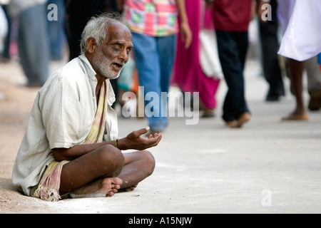 Old blind Indian beggar on the street in front of a crowd. Andhra Pradesh, India Stock Photo