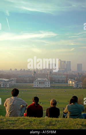 Vertical view of tourists watching the sun set over London's skyline from the top of Greenwich Park. Stock Photo