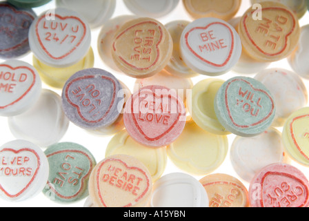 Horizontal close up elevated view of a pile of colourful loveheart sweets on a white background Stock Photo