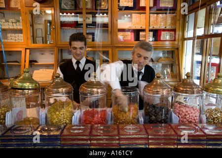 Serving sweets inside the Haci Bekir shop in Istanbul Turkey. Famous for their Turkish Delight. Stock Photo