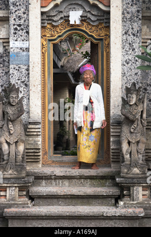 Elderly Woman Standing In Ornate Doorway Stock Photo