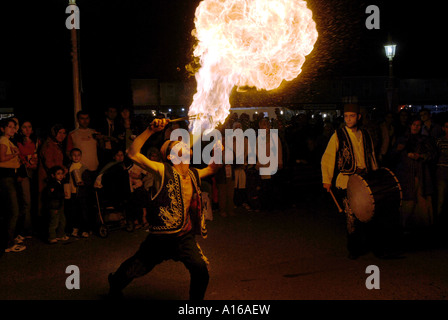 TURKISH MAN BLOWING FIRE WITH HIS MOUTH FULL OF FLAMMABLE GAS AS A PART OF RAMADAN FESTIVAL IN ISTANBUL TURKEY Stock Photo