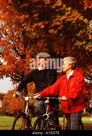 Fall Colors Healthy active retired senior couple on bicycles Stock Photo