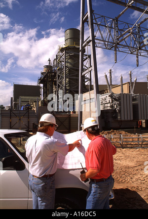 Two electricians consulting blueprints Stock Photo