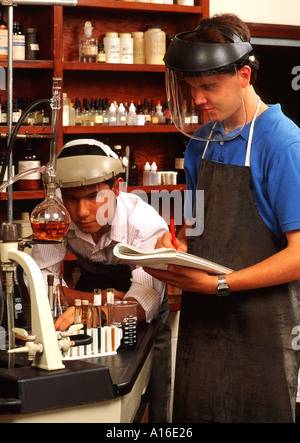 High school two boys wearing protective gear in science class Stock Photo