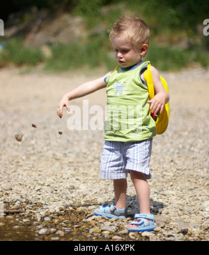 Little naked boy playing at the river bank Stock Photo - Alamy