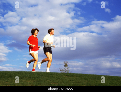 Attractive middle aged couple jogging together Stock Photo