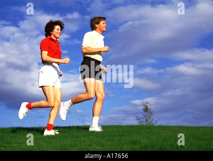 Attractive middle aged couple jogging together Stock Photo