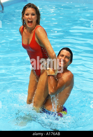 Attractive middle aged couple playing in the pool Stock Photo