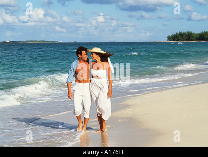 Attractive young couple walking on the beach Stock Photo