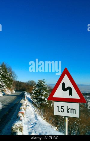 A road through the Snowy forest, Brasov, Transylvania, Romania. Stock Photo