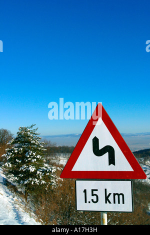 A road through the Snowy forest, Brasov, Transylvania, Romania. Stock Photo