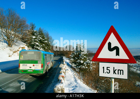 A road through the Snowy forest, Brasov, Transylvania, Romania. Stock Photo