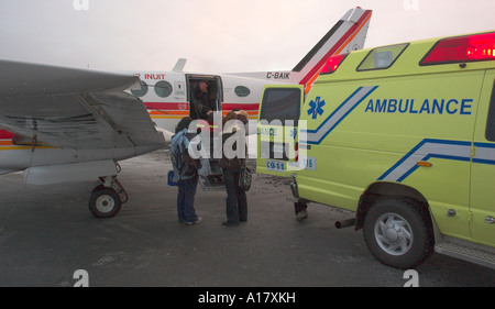 Young doctors getting ready to board a plane for an emergency medical evacuation in the arctic town of Kuujjuaq Stock Photo