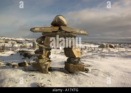 An inukshuk on a hill overlooking the arctic village of Kuujjuaq Stock Photo