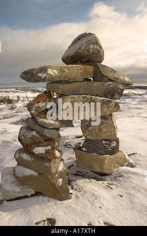 An inukshuk on a hill overlooking the arctic village of Kuujjuaq Stock Photo