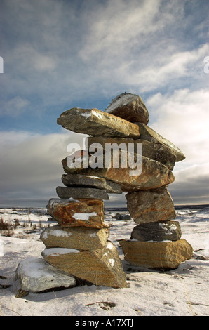 An inukshuk on a hill overlooking the arctic village of Kuujjuaq Stock Photo