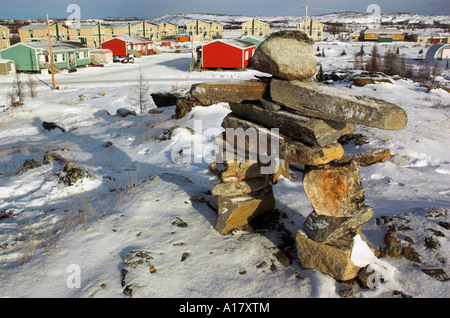 An inukshuk on a hill overlooking the arctic village of Kuujjuaq Stock Photo