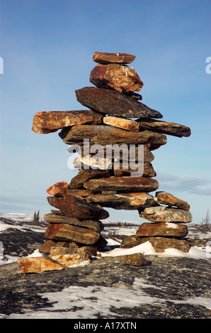 An inukshuk on a hill overlooking the arctic village of Kuujjuaq Stock Photo