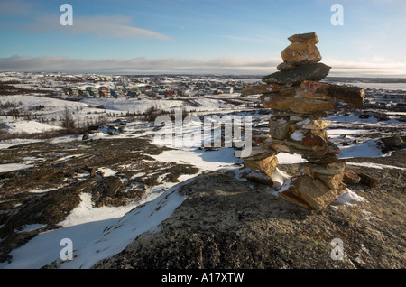 An inukshuk on a hill overlooking the arctic village of Kuujjuaq Stock Photo