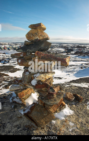 An inukshuk on a hill overlooking the arctic village of Kuujjuaq Stock Photo