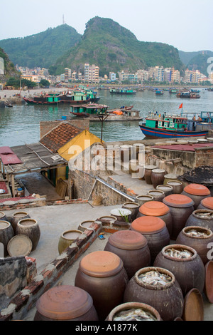 Fish and Shrimp Paste and Sauce Factory Cat Ba Town in the distance Halong Bay Vietnam Stock Photo