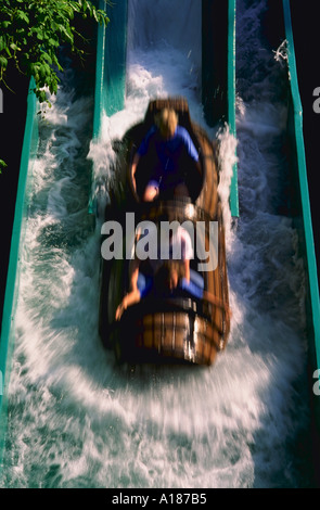 Blurred view of three people riding the log flume amusement park ride at Busch Gardens Theme Park in Virginia Stock Photo