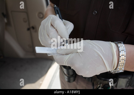 Deputy sheriff using MethCheck to test if a suspicious substance found ...