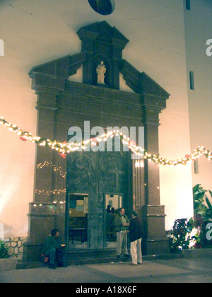 Spanish Homeless Beggar outside a church at Christmas, homeless homelessness destitute destitution poor poverty beggar begging Stock Photo