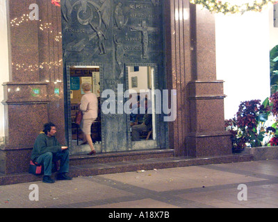 Spanish Homeless Beggar outside a church at Christmas, homeless homelessness destitute destitution poor poverty beggar begging Stock Photo