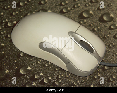 Computer mouse with scrolling wheel on grey patterned mouse pad Stock Photo