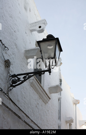 Street light on a whitewashed wall  in the ancient city of Ceglie Messapica, Puglia, Southern Italy. Stock Photo