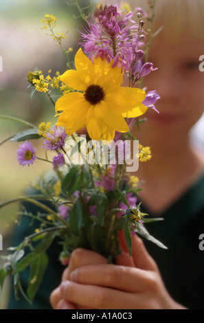 Boy Holding Wildflower Bouquet Stock Photo