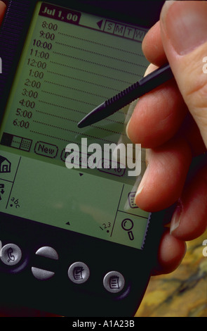 Close up of a hand and a electronic personal data organizer Stock Photo